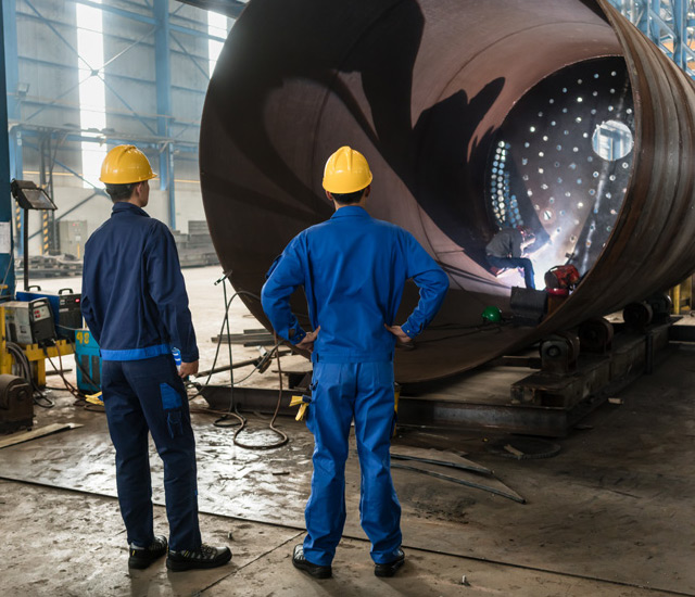 Workers Reviewing Manufacturing Quality